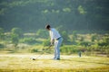 Golfer sport course golf ball fairway.ÃÂ  People lifestyle man approach playing game golf tee off on the green grass. Royalty Free Stock Photo